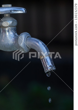 Water drops falling from the faucet 130132379