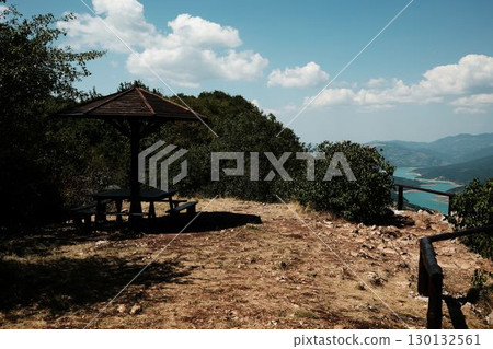 Wooden picnic shelter on mountain viewpoint overlooking Zavoj lake and forest in Stara Planina, Serbia Wooden picnic shelter on mountain viewpoint overlooking Zavoj lake and forest in Stara Planina, Serbia 130132561