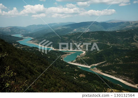 Winding turquoise river and green forested mountains in Stara Planina, Serbia. Scenic aerial view of Zavoj Lake 130132564