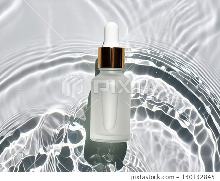 A glass dropper bottle on water surface, top view A glass dropper bottle on water surface, top view 130132845