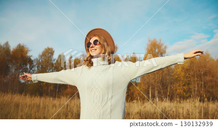 Stylish modern happy young woman having fun dancing, fashionable girl smiling outdoors, autumn park 130132939
