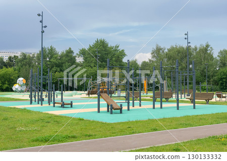 sports ground and playground for children in the city park on a sunny summer day 130133332