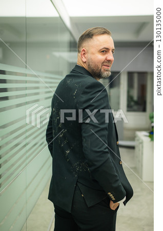 Caucasian man in dirty jacket in office.  130135000