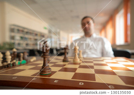 Middle aged Caucasian man playing chess. Middle aged Caucasian man playing chess. 130135030
