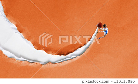 Modern collage. Basketball player dunking ball on torn paper background with energy Modern collage. Basketball player dunking ball on torn paper background with energy 130135080