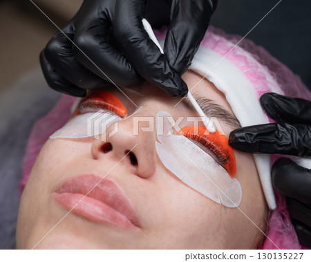 Caucasian woman undergoing eyelash lamination procedure.  130135227
