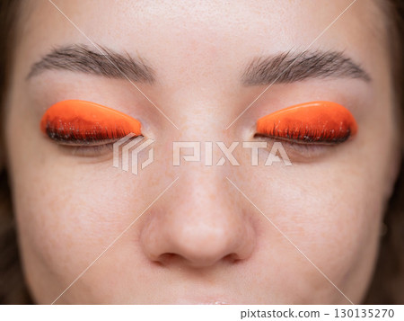 Caucasian woman undergoing eyelash lamination procedure. top view.  130135270