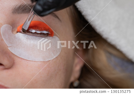 Caucasian woman undergoing eyelash lamination procedure.  130135275