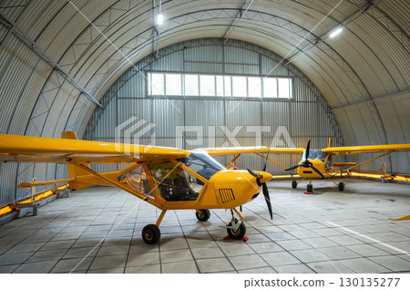 Yellow airplane glider in the hangar. Yellow airplane glider in the hangar. 130135277