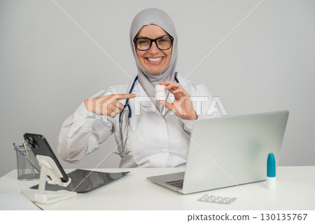 Female doctor in hijab recommends medications.  130135767
