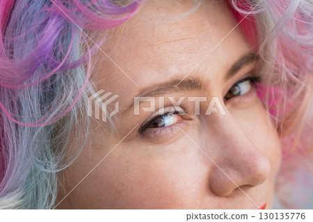 Close-up portrait of Caucasian woman with multi-colored hairstyle.  130135776