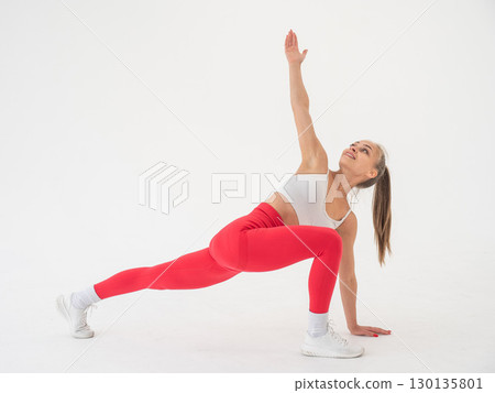 Caucasian woman doing sports exercises on white background.  130135801