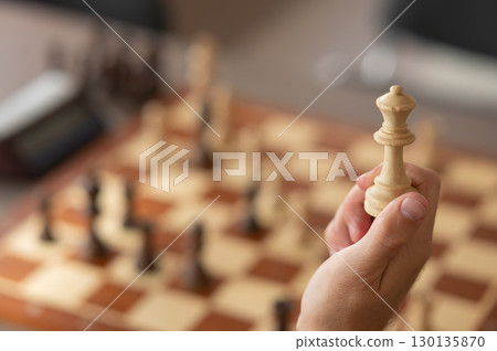 Close up of hands of middle aged caucasian man playing chess. Close up of hands of middle aged caucasian man playing chess. 130135870