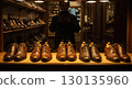 Rows of new shoes in dark shop create sharp contrast to tragic history 130135960