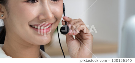 Close-Up of Call Center Agent Smiling with Headset 130136140