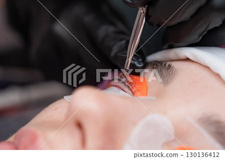 The process of professional lamination and tinting of eyelashes in the salon. 130136412