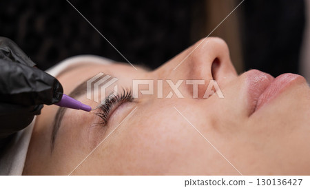 The process of professional eyelash lamination in a salon. The process of professional eyelash lamination in a salon. 130136427