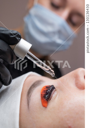 The process of professional lamination and tinting of eyelashes in the salon. The process of professional lamination and tinting of eyelashes in the salon. 130136430