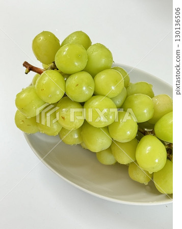 Fresh Shine Muscat grapes, known for their crisp texture and sweet, refreshing taste. Perfect for showcasing premium fruit, ideal for food photography, healthy eating concepts, and gourmet projects. 130136506