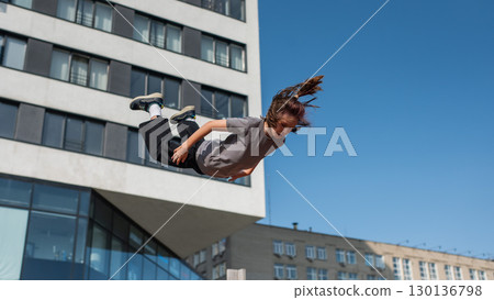 A girl jumps on an outdoor trampoline. A girl jumps on an outdoor trampoline. 130136798