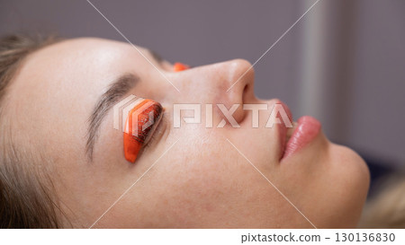 Caucasian woman undergoing eyelash lamination procedure. Caucasian woman undergoing eyelash lamination procedure. 130136830
