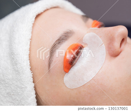 Caucasian woman undergoing eyelash lamination procedure.  130137001