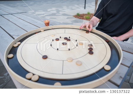 Strategic Game Pieces on a Wooden Board crokinole.  130137322