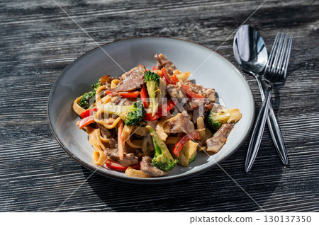 Pasta with beef, mushrooms and vegetables.  130137350