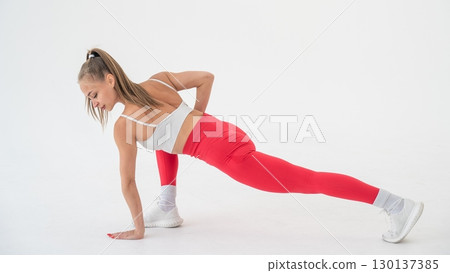 Caucasian woman doing sports exercises on white background. Caucasian woman doing sports exercises on white background. 130137385