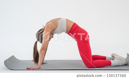 Caucasian woman doing sports exercises on white background.  130137388