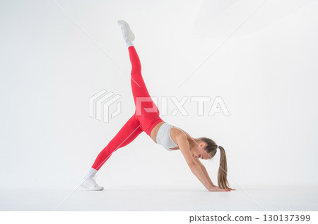 Caucasian woman doing sports exercises on white background. Caucasian woman doing sports exercises on white background. 130137399
