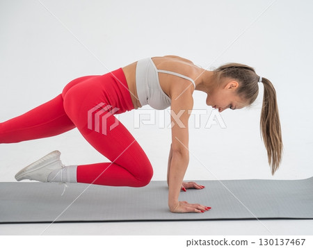 Young woman doing plank exercise on white background. Young woman doing plank exercise on white background. 130137467