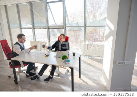 Colleagues drinking coffee in the office.  130137538