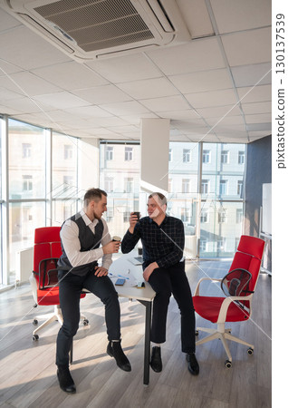 Colleagues drinking coffee in the office.  130137539