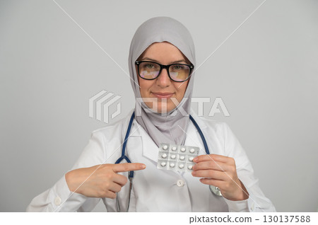Female doctor in hijab recommends medications.  130137588