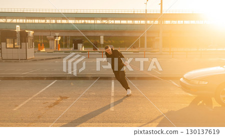 Caucasian man pulling a car with a rope. Caucasian man pulling a car with a rope. 130137619