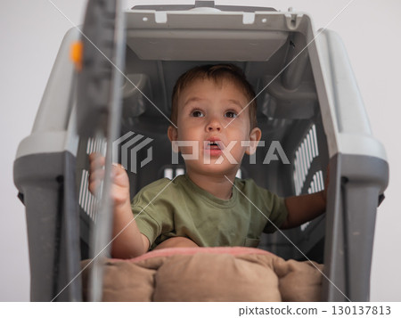 A small child in a closed cage. A small child in a closed cage. 130137813