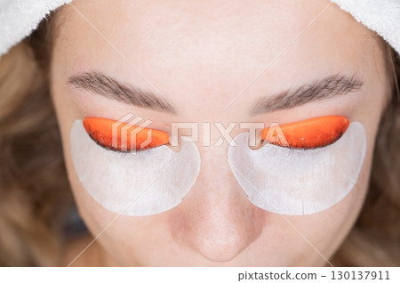 Caucasian woman undergoing eyelash lamination procedure. top view. Caucasian woman undergoing eyelash lamination procedure. top view. 130137911