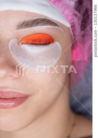 Caucasian woman undergoing eyelash lamination procedure. top view.  130137966