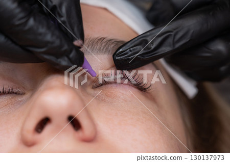 The process of professional eyelash lamination in a salon. The process of professional eyelash lamination in a salon. 130137973