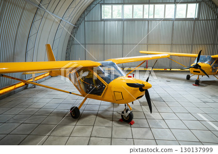Yellow airplane glider in the hangar. Yellow airplane glider in the hangar. 130137999