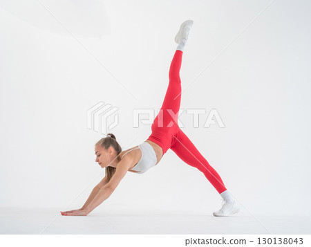 Caucasian woman doing sports exercises on white background. Caucasian woman doing sports exercises on white background. 130138043
