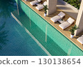 Aerial view of luxury poolside with white lounge chairs 3d render 130138654