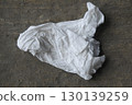crumpled paper sheet on wood 130139259