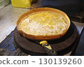 pie with cheese on the kitchen table 130139260