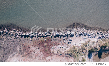 Rocky Coastline Meets Turquoise Waters in Stunning Drone Captured Aerial Perspective 130139647