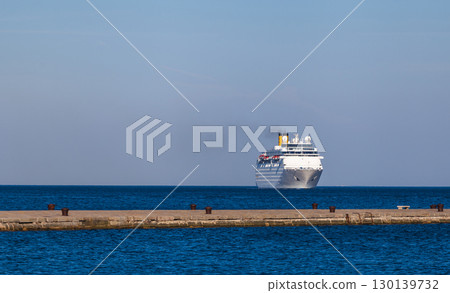 Luxury Cruise Ship Approaching Mediterranean Harbor Through Crystal Blue Waters 130139732