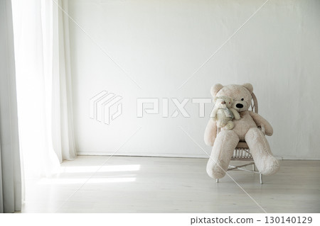 bear plush toy in the interior of a white room 130140129