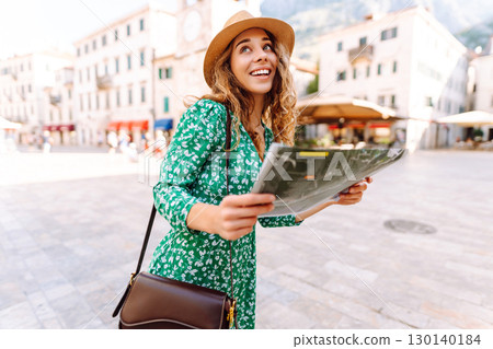 Portrait beautiful woman with paper map on urban street. Exploring interesting places to travel. Portrait beautiful woman with paper map on urban street. Exploring interesting places to travel. 130140184