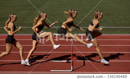 Sequence of female athlete running and jumping hurdle on stadium track 130140489